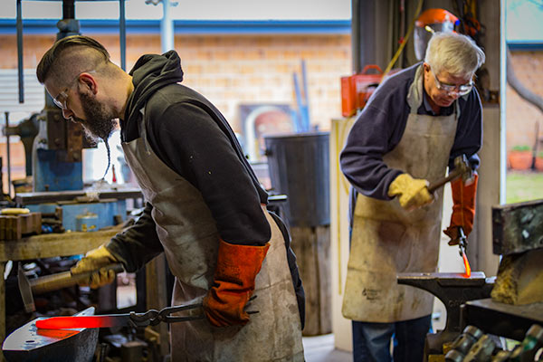 Father and Son forging knives